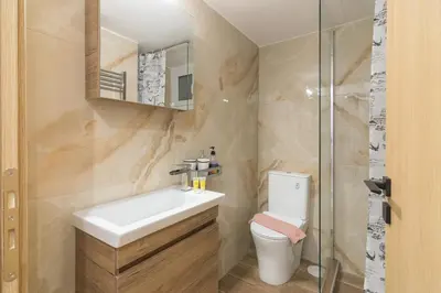 a bathroom with a sink and a toilet and a shower at Luxury Apartment for 5 Ppl in the Center of Athens in Athens