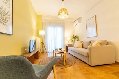 a living room with a couch and a tv at Acropolis Central Living in Athens