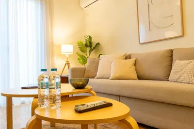 a living room with a couch and two water bottles on a table at Acropolis Central Living in Athens