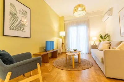 a living room with a couch and a table at Acropolis Central Living in Athens