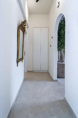 a hallway with a white door and a mirror at BAMBOO Athens Villa in Athens