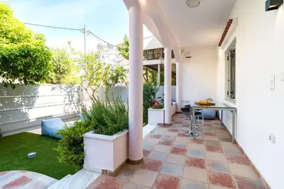 an outdoor patio with a table and plants on a building at BAMBOO Athens Villa in Athens