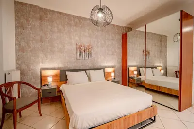 a bedroom with a bed and a desk and a chair at Flisvos Halcyon in Athens