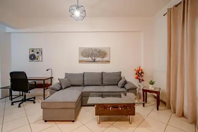 a living room with a couch and a table at Flisvos Halcyon in Athens