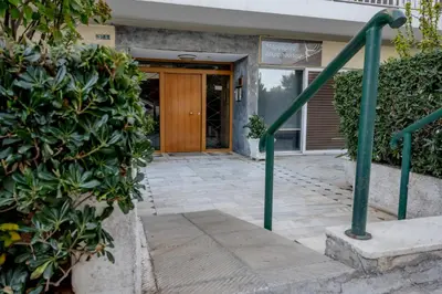 a front door of a house with green railing at Flisvos Halcyon in Athens