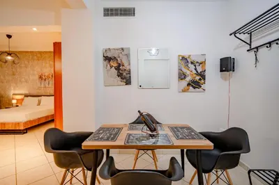 a room with a desk with chairs and a bed at Flisvos Halcyon in Athens