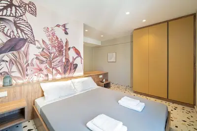 a bedroom with a bed and a painting on the wall at Casa Arcobaleno Athens in Athens