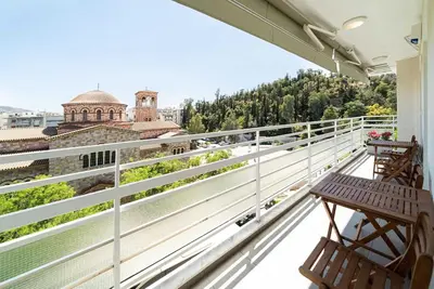 a balcony with two benches and a view of the city at Casa Arcobaleno Athens in Athens