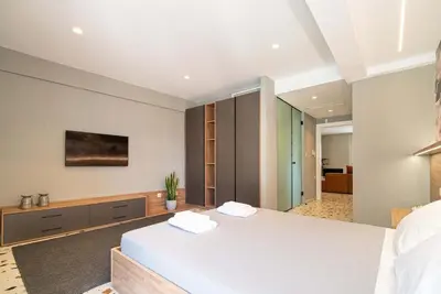 a bedroom with a large white bed in a room at Casa Arcobaleno Athens in Athens