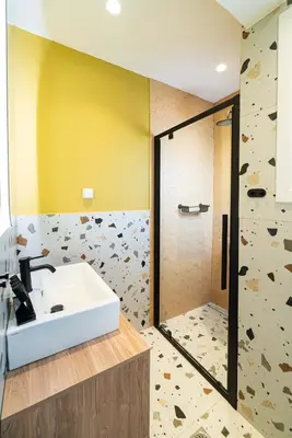 a bathroom with a sink and a rock wall at Casa Arcobaleno Athens in Athens