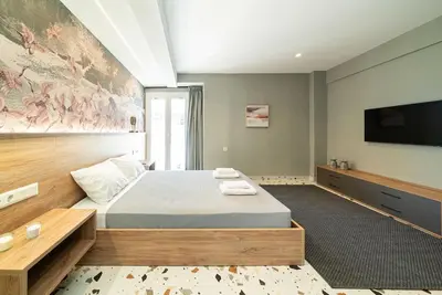 a bedroom with a bed and a flat screen tv at Casa Arcobaleno Athens in Athens
