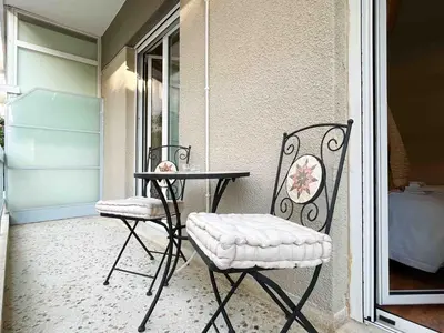 a pair of chairs and a table on a porch at Restful Flat in Glyfada Center in Athens