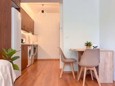 a kitchen and dining room with a table and chairs at Restful Flat in Glyfada Center in Athens