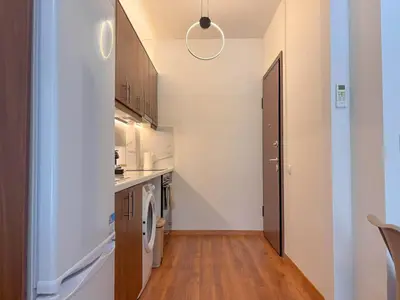 a small kitchen with a washer and dryer at Restful Flat in Glyfada Center in Athens