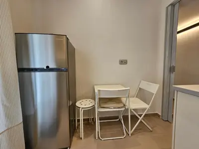 a kitchen with a refrigerator and a table and chairs at OLYMPIC Perfect Base to Explore Athens, Central Penthouse near metro and train in Athens