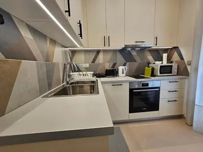 a kitchen with a sink and a microwave at OLYMPIC Perfect Base to Explore Athens, Central Penthouse near metro and train in Athens