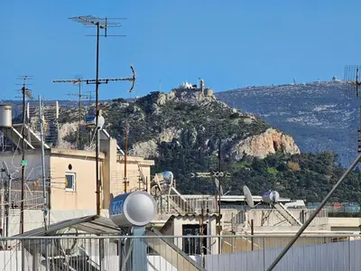 a mountain with a castle on top of it at OLYMPIC Perfect Base to Explore Athens, Central Penthouse near metro and train in Athens