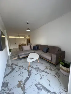 a living room with a couch and a table at Varkiza Zen Space in Vari