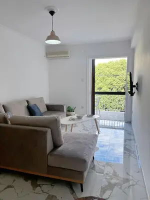 a living room with a couch and a table at Varkiza Zen Space in Vari