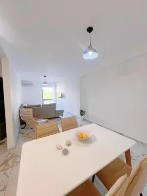 a living room with a white table and chairs at Varkiza Zen Space in Vari