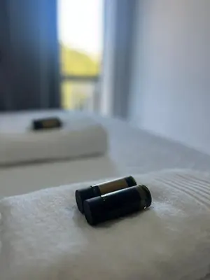 a black object is laying on a bed at Varkiza Zen Space in Vari