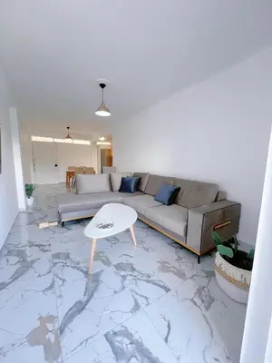 a living room with a couch and a table at Varkiza Zen Space in Vari