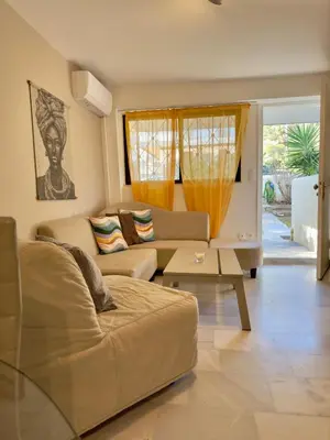 a living room with a couch and a table at 2' from Beach Cozy & Renovated Maisonette in Porto Rafti