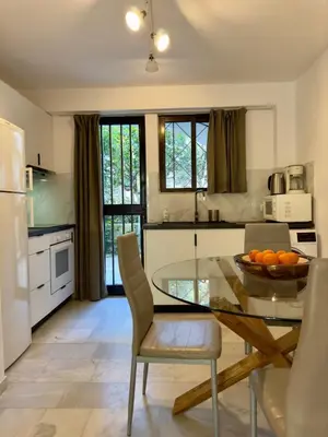 a kitchen with a glass table and chairs at 2' from Beach Cozy & Renovated Maisonette in Porto Rafti