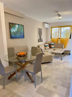 a living room with a glass table and chairs at 2' from Beach Cozy & Renovated Maisonette in Porto Rafti