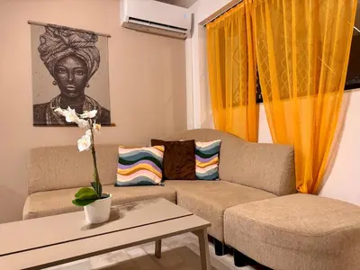 a living room with a couch and a table at 2' from Beach Cozy & Renovated Maisonette in Porto Rafti