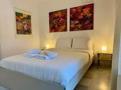 a bedroom with a white bed with towels on it at 2' from Beach Cozy & Renovated Maisonette in Porto Rafti