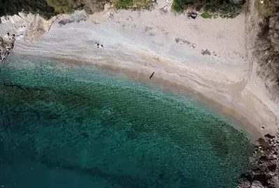 an aerial view of a beach with people in the water at 2' from Beach Cozy & Renovated Maisonette in Porto Rafti