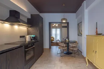 a kitchen with a table and a dining room at Ilisia Home in Athens