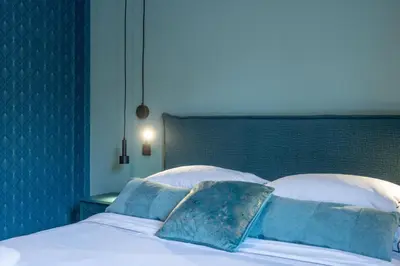 a bed with two pillows on top of it at Ilisia Home in Athens