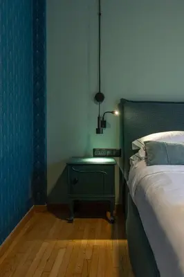 a bedroom with a bed and a table with a lamp at Ilisia Home in Athens