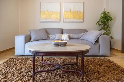 a living room with a couch and a coffee table at Ilisia Home in Athens