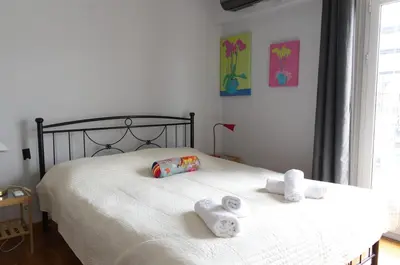 a bedroom with a bed with two towels on it at Funky Apartment in Athens