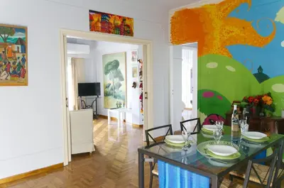 a living room with a table and a dining room at Funky Apartment in Athens