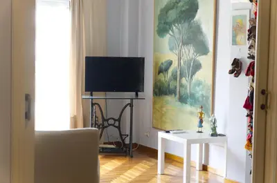 a living room with a tv and a table at Funky Apartment in Athens