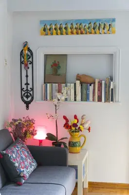 a living room with a couch and a table with flowers at Funky Apartment in Athens