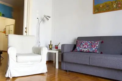 a living room with a couch and a chair at Funky Apartment in Athens