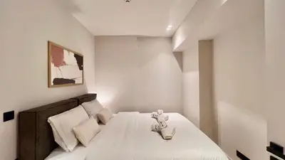 a bedroom with a bed with a white bedspread at The First by 22 in Piraeus