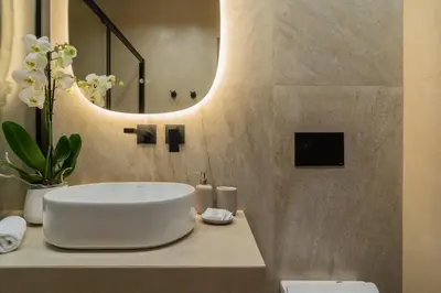 a bathroom with a white sink and a mirror at Elegant Suite Syntagma 2BR 2BA in Athens