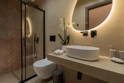 a bathroom with a sink and a toilet and a mirror at Elegant Suite Syntagma 2BR 2BA in Athens