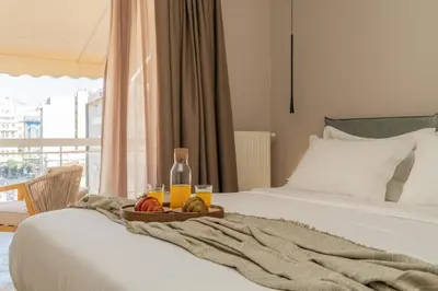 a tray of fruit and a bottle of orange juice on a bed at Elegant Suite Syntagma 2BR 2BA in Athens
