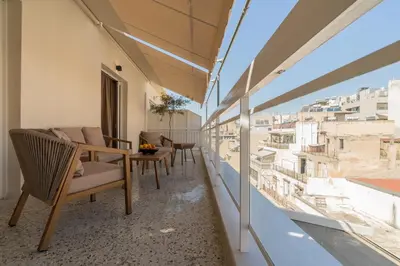 a balcony with chairs and a view of the city at Elegant Suite Syntagma 2BR 2BA in Athens