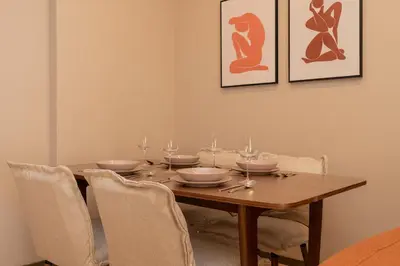 a dining room with a wooden table and chairs at Elegant Suite Syntagma 2BR 2BA in Athens