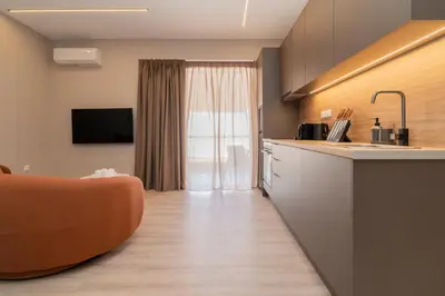 a kitchen with an orange couch in a room at Elegant Suite Syntagma 2BR 2BA in Athens