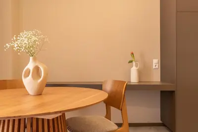 a table and chairs with a vase on it at Elegant Suite Syntagma A2 in Athens