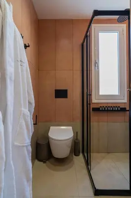 a bathroom with a toilet and a window at Elegant Suite Syntagma A2 in Athens